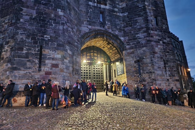 People gather at the castle gates for the vigil.