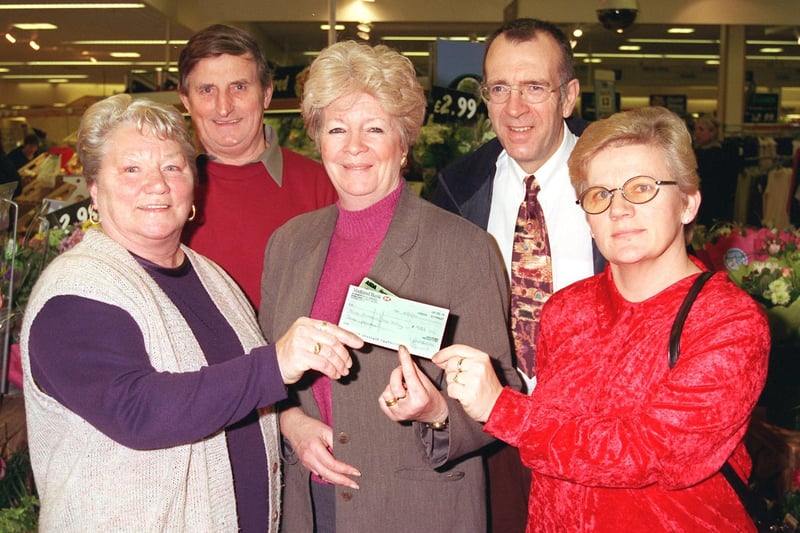 Customer Services Manager at Asda in Lancaster, Pat Parrott, presents a cheque for £933 to the Children's Holiday Of A Lifetime Society with, from left, June Calvert, Alan Calvert, Nigel Reeves and Josie Wilcock. The money was raised at the Millennium fireworks display, and cheese and wine evening.