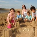 Building sandcastles on Morecambe beach are the Mann family from Lancaster - Laura, Alex, Joel, Im and Gonzalo Chiva.
