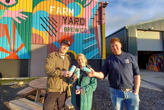 Macmillan’s local Fundraising Manager Louise Osgood (centre) with Farm Yard Brew Co’s Steven Holmes (left) and Danny Ellidge (right).