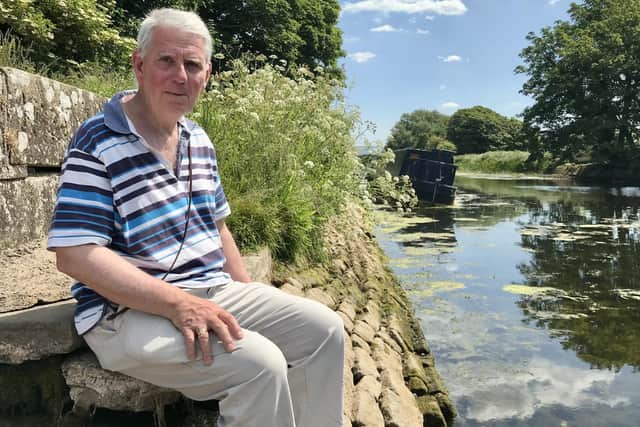 Parish councillor Nicholas Thorn at the Glasson Branch of Lancaster Canal. A boat can be seen tilting, the canal banks exposed and a low water level. Picture: Robbie MacDonald.