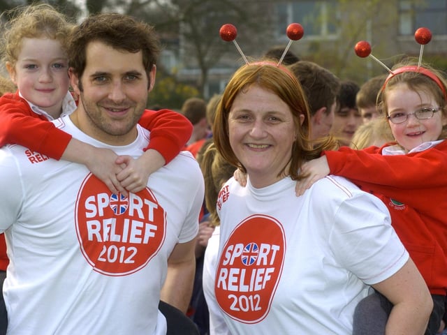 Morecambe High School teacher Alison Holhead with her children, Imogen and Eleanor Holhead, and fellow teacher Phil Watson, who took part in a piggy back race as part of a mass egg and spoon race, piggy back and three legged race world record attempt on Sport Relief Day.