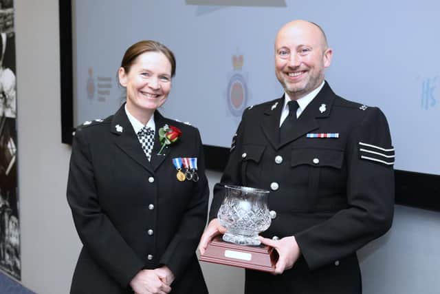 Chief Superintendent Karen Edwards, West Divisional Commander, with Sergeant Lindsay Brown and his award in recognition of his hard work during the Covid-19 pandemic.