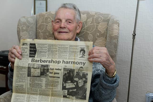 Tom Rogerson, who is turning 100 in April, holding a copy of the Lancashire Evening Post containing an article written when he retired. Photo: Kelvin Stuttard