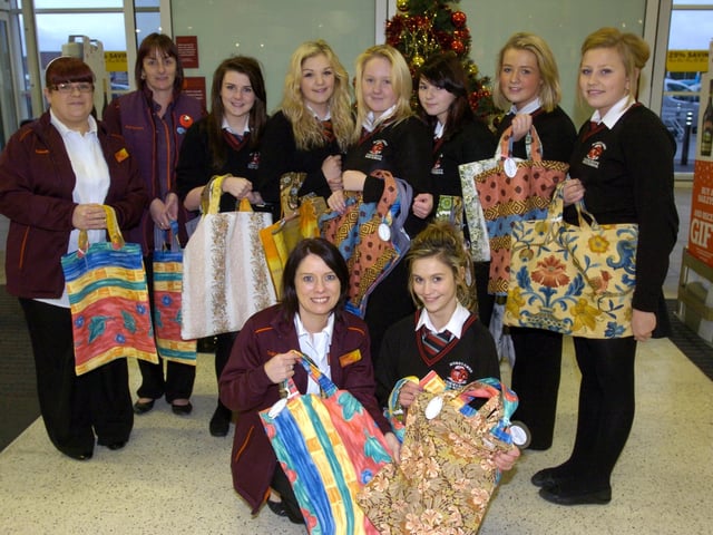 Year 10 Textile Studies students, Holly Brierley, Kirsty Wolff, Livia Barmby, Tiffany Airey, Helen Mawson, Sian Spencer and Claudia Duszczynski, who donated shopping bags made out of recycled material to shoppers at the Sainsbury's store in Morecambe, pictured with staff members, Jane Slater, Selina Berry and Trish Wood.