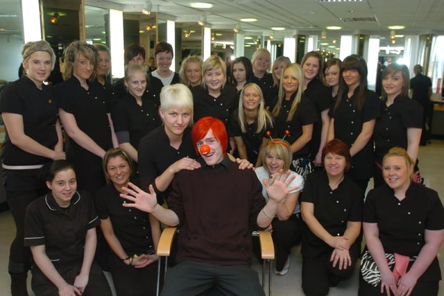 Liam Drinkwater, a level 2 NVQ Hairdressing student at Lancaster and Morecambe College in 2009, had his hair dyed red and then cut by stylist Lisa Care, raising £150 for Comic Relief. He is pictured with fellow Level 2 NVQ Hairdressing students.