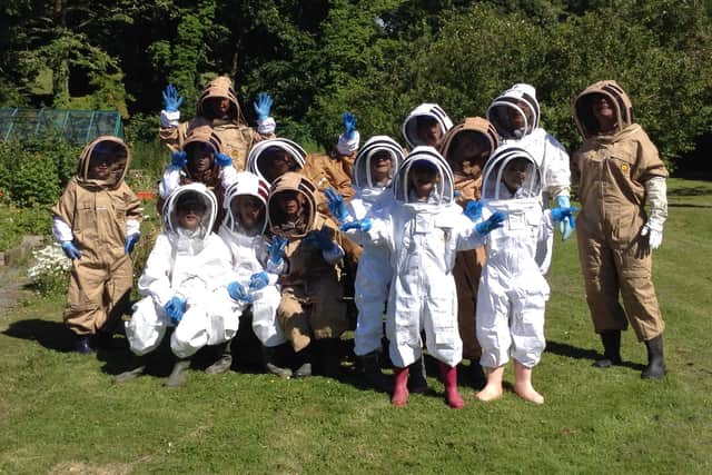 Children from Bolton-le-Sands Primary School's bee club visit the school's new apiary.