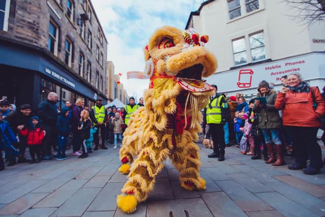 A Chinese lion takes a breather at Horseshoe Corner during last year's New Year Festival in Lancaster.