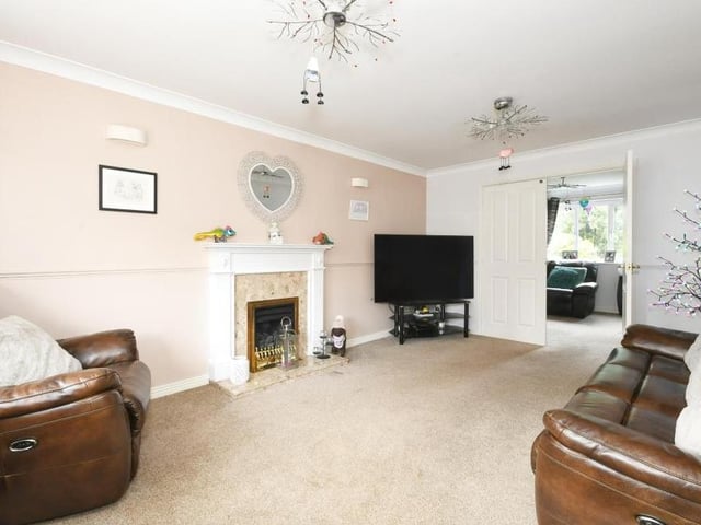 A second shot of the living room, which clearly lends itself to relaxing nights in front of the fire and TV. Internal doors lead to a second reception room which, at present, is being used as a dining room.