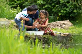 Children pond dipping with an RSPB volunteer - by RSPB (rspb-images.com).