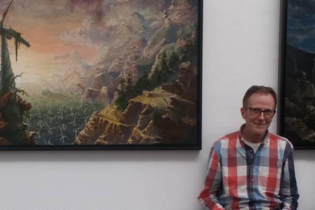 James Mackie with his paintings at last year’s Art of Music exhibition curated by King Street Arts (KSA).
