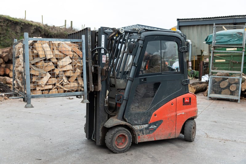 Wood is lifted into place by a forklift truck at Logs Direct.