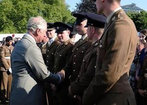 Alex Doolan shakes hands with Prince Charles at his 70th birthday party.