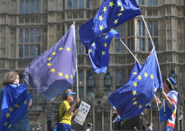 Activists wave European Union and Union flags outside the Houses of Parliament in Westminster, London. PRESS ASSOCIATION Photo. Picture date: Tuesday May 8, 2018. Theresa May will be forced to abandon proposals for a "customs partnership" with the EU, a leading Conservative Brexiteer has warned. See PA story POLITICS Brexit. Photo credit should read: Victoria Jones/PA Wire