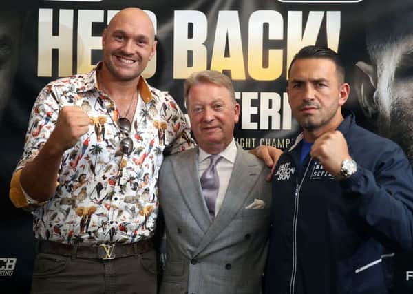Tyson Fury (left), Sefer Seferi (right) and promoter Frank Warren during the press conference at The Midland Hotel, Manchester.