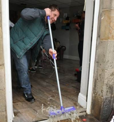 Photo Neil Cross
Cleaning up after the floods at Galgate