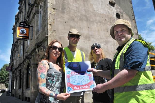 Photo: David Hurst Massive Wagons Band Manager Terri Chapman, left and Tour Manager Neil Hunter, second from left, with painters Kaption 1 and Kid30, right and the design that is being painted on the side of The Pub, Lancaster