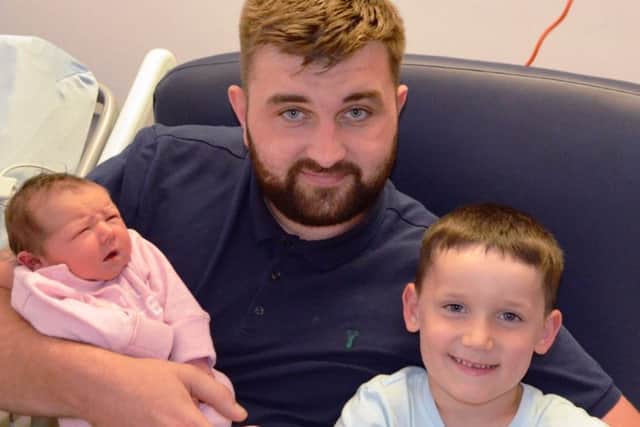One of seven babies born at UHMBT on the anniversary of the NHS Dad Lee Hall, baby Olivia Hall and her brother George Ellis.jpg