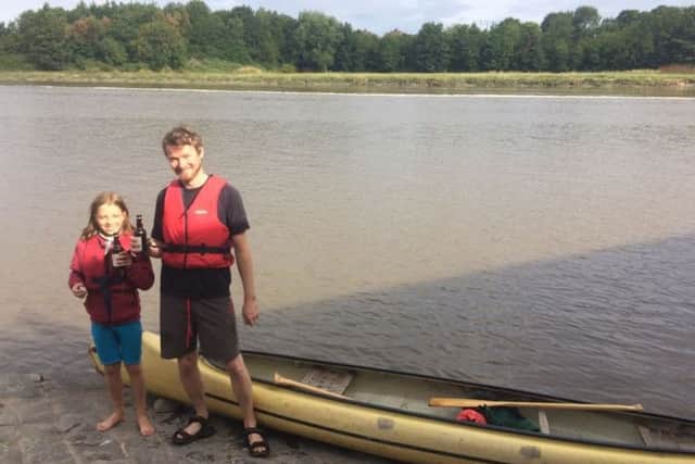 Reuben Gittens with dad Tom after taking their canoe to school.