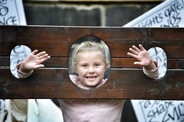 Picture by Julian Brown 18/08/18

Having a go in the stocks is Madeleine Colclough (5)

Lancashire Witches weekend at Lancaster Castle