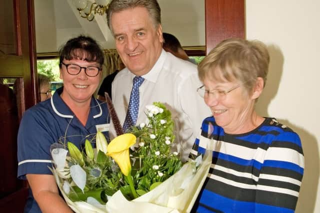 Matron Sandra Connelly presenting flowers on behalf of staff to George and Marie Hill. Photo by Glynn Ward.