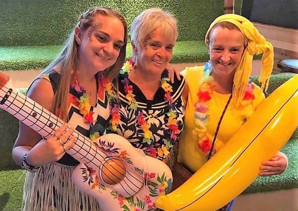 Georgie Whittle with Colette and Claire Nixon at the Caribbean Night held at The Greyhound pub, Halton, in aid of CancerCare.
