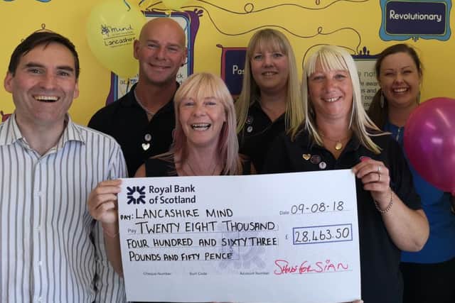 Sian Waterhouse' family presents a cheque to Lancashire Mind for Â£28.463.50 from events held in Sian's memory.