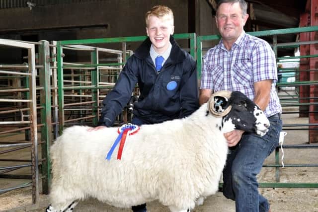 Picture by Julian Brown 01/09/18

Judge Ryan Capstick and Brian Knowles with his first prize winning Rough Fell Two Shear Ewe

Bentham Show
