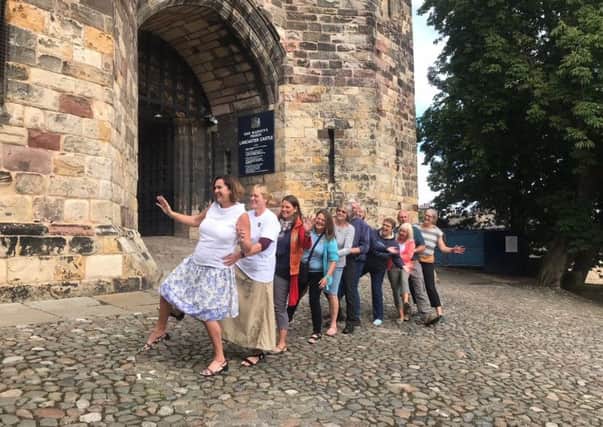 Staff from UHMBT get into the conga spirit at Lancaster Castle