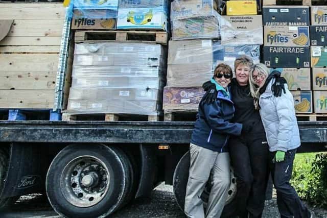 From left: Julie Vallance, Carole Roberts and Maria Ward with a lorry load of aid from Lancaster and Liverpool.