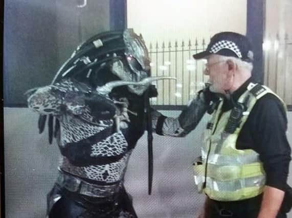 Police officer and 'Predator' squaring off