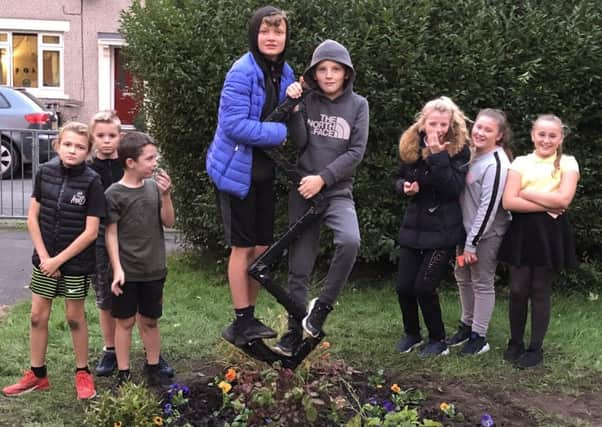 Youngsters work on the memorial garden for Leon Hoyle.
