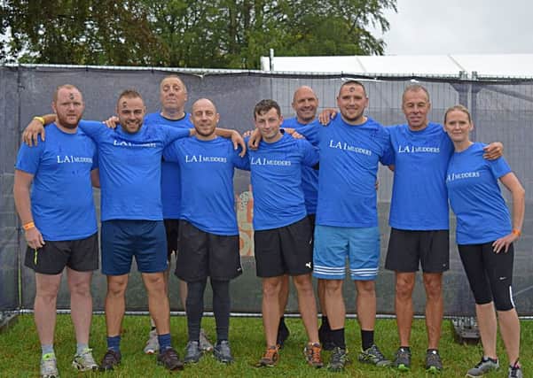 Employees and customers at LA1 Construction Ltd completed a Tough Mudder challenge to raise money for two charities.