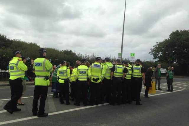 Police surround Coun Caroline Jackson outside Cuadrilla's fracking site in Preston New Road.