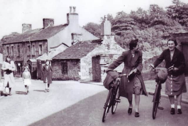 Smithy Brow, Wray Main Street, around 1958. The smithy is already starting to decay. The roof of the horse shoeing building has collapsed.
The lady on the right of the photograph is Ethel Townson whose ancestors were butchers in the village in the 17th century. The sharp bend in this street was known locally as Mucky Corner, probably because the cows from Roeburnside Farm would be taken down to the river in winter for watering.