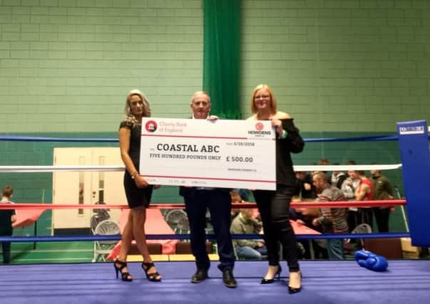 Coastal boxing gym receives a cheque from its sponsor, Howdens.