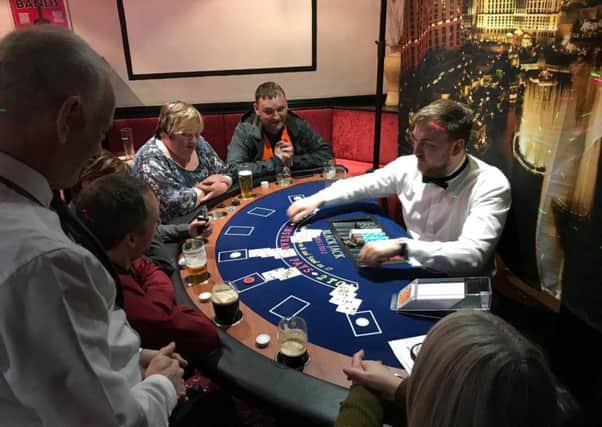 'Gamblers' enjoying a spot of blackjack at a charity casino night.