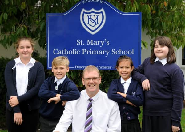 Peter Harrison has become the new headteacher of St Mary's Primary School in Morecambe.  He is pictured with pupils Joanna, Oliver, Phoebe and Jasmine.