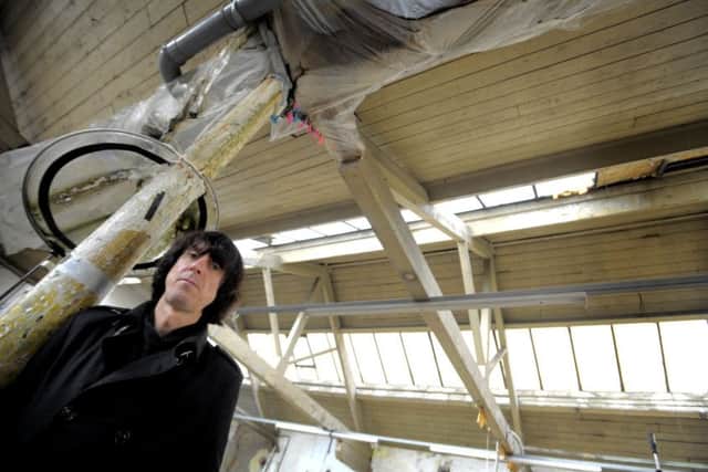 David Blackwell and the leaking roof at the Music co-op Lancaster in 2012.