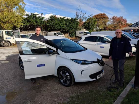 Council Vehicle Maintenance Unit staff Scott Cunningham and John Sharman with one of the new Renault Zoes