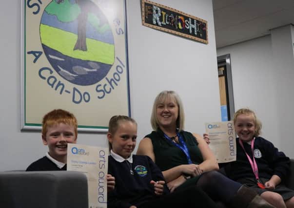 Alison Dodd, head teacher, with pupils  Connor, Molly and Maisie.