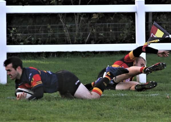 Harry Ralston scores a try for Kirkby Lonsdale.