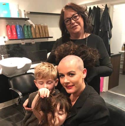 Rachel Holme pictured after her charity head shave, with son Joseph, nine, and daughter Georgia, three.