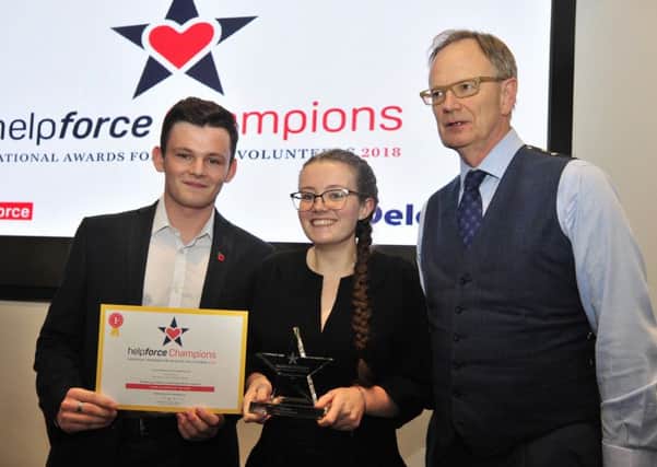 Louise Munro (middle) with Connor Tomlinson (left) of the NHS Youth Forum who presented the award and Sir Tom Hughes-Hallett (right), Founder and Chair of Helpforce.