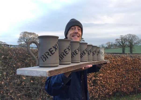 Lee Cartledge with the first eight of the Brexit mugs