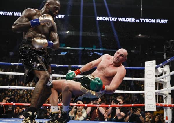 Deontay Wilder sends Tyson Fury to the floor. Picture: Esther Lin / Showtime.