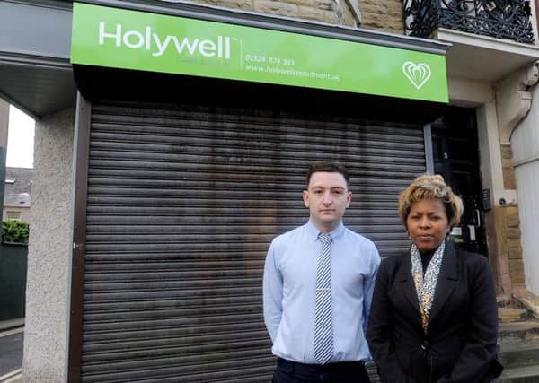 Holywell Recruitment on West End Road have been told their shutters are not in keeping with the area.  Pictured outside is recruitment consultant Luke Dewhurst with owner Sabe Connor.