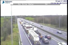 Traffic is queuing to merge into the open outside lane on the M6.