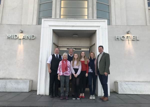 Sarah Oliver and family with Midland Hotel duty manager Kevin Hardy.