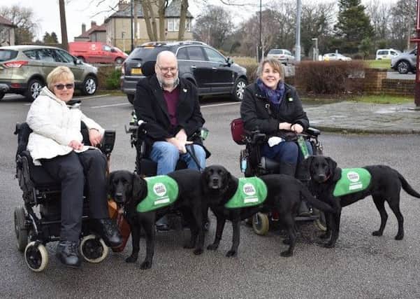 Dogs for Good celebrates 30 years of making life changing differences for people with disabilities. Pictured from left are Lynn Matthews and Christa, Martyn Blenkharn and Isa, and Wendy and Hallie.